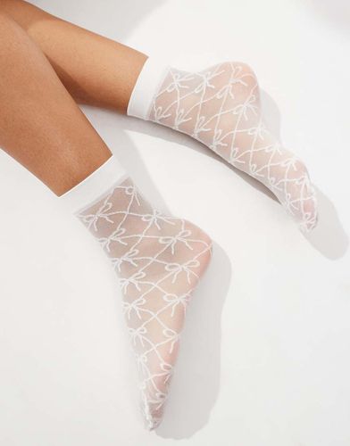 Chaussettes transparentes à motif naud - Asos Design - Modalova