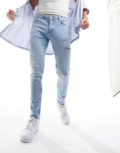 Jean skinny à grosses déchirures - délavé clair - Asos Design - Modalova