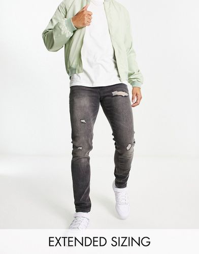 Jean skinny avec abrasions - délavé - Asos Design - Modalova