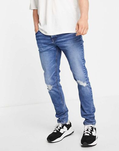 Jean skinny avec déchirures aux genoux - délavé foncé - Asos Design - Modalova