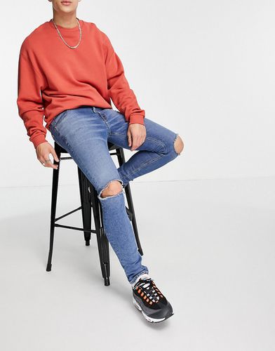 Jean skinny avec genoux déchirés - moyen - Asos Design - Modalova