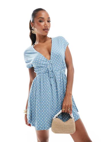 Robe à pois courte et froissée style rétro à manches courtes et col V avec liens noués à l'avant - Bleu - Asos Design - Modalova