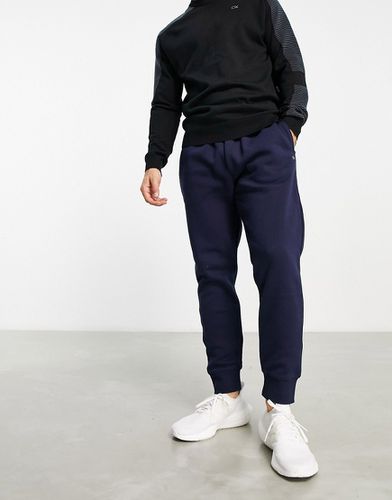 Exclusivité ASOS - Calvin Klein - Pantalon de jogging à monogramme imprimé sur l'ensemble - Calvin Klein Golf - Modalova