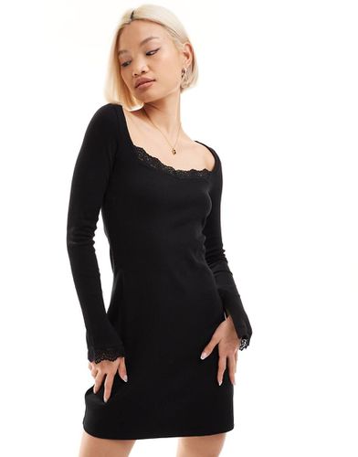 Robe courte à manches longues avec détails en dentelle - Monki - Modalova