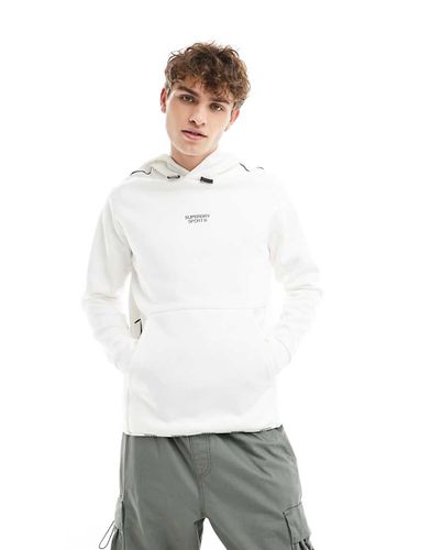 Sport - Sweat à capuche ample en tissu technique avec logo - craie - Superdry - Modalova