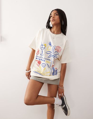 T-shirt oversize en coton avec dessins style vacances - beurre - Reclaimed Vintage - Modalova