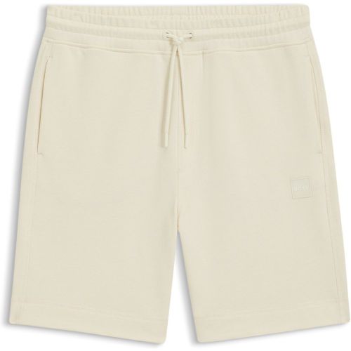 Short Relaxed en molleton de coton avec badge logoté - Boss - Modalova