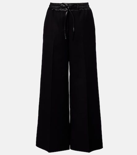 Alaïa Pantalon ample en laine vierge et cuir - Alaia - Modalova