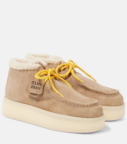 Bottines en cuir et shearling - Miu Miu - Modalova